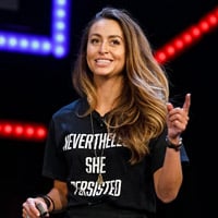 britney testimonial a picture of a woman wearing a black t-shirt on stage